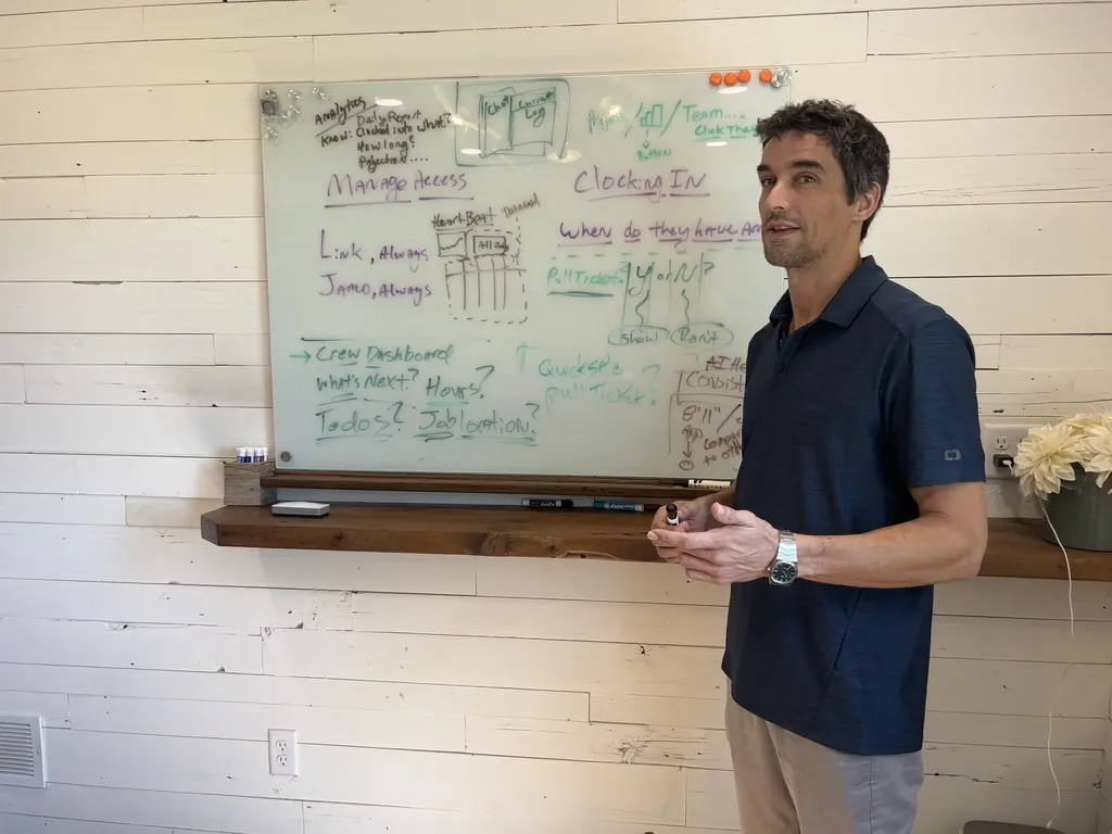 Tyler Garrett, founder of dev3lop, diagramming a platform on a glass whiteboard