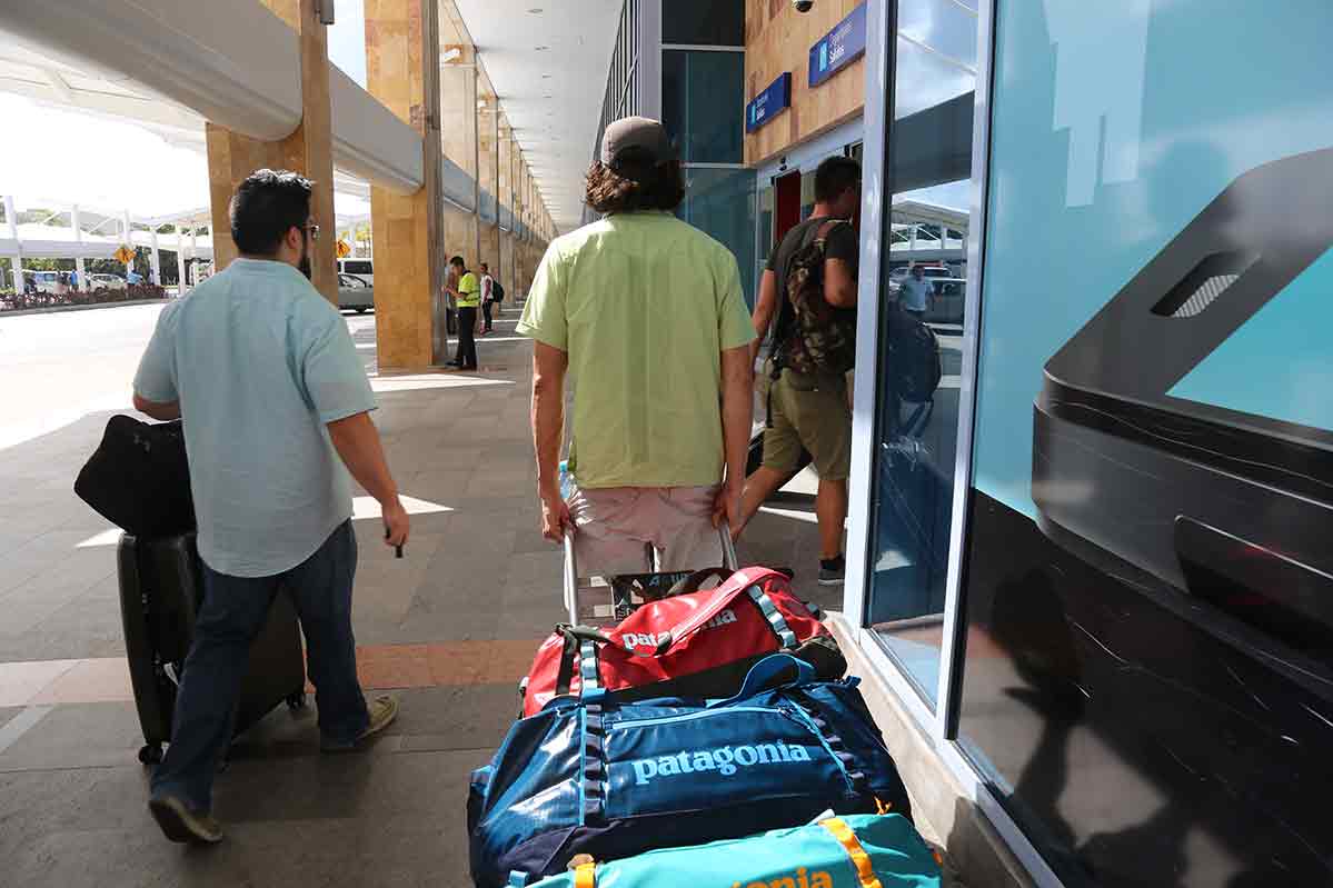 Tyler Garrett with packed bags at an airport, leaving the hosting company!